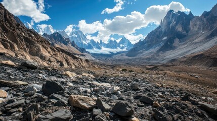 Glacier erosion carving out deep valleys in a rugged mountain range, leaving behind rocky debris