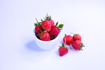 Ripe strawberries on white bowl