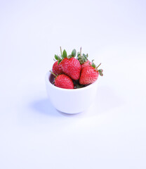 Ripe strawberries on white bowl