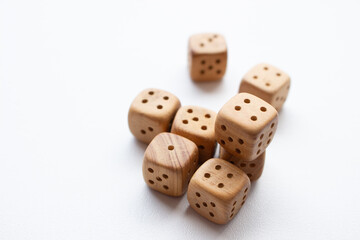 These are photos of wooden dice on a white background. They include shots of aligned, scattered, and stacked dice There are photos of a single die, a pyramid of dice.