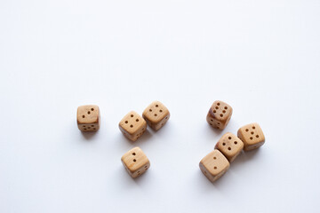These are photos of wooden dice on a white background. They include shots of aligned, scattered, and stacked dice There are photos of a single die, a pyramid of dice.