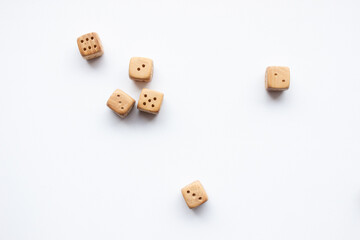 These are photos of wooden dice on a white background. They include shots of aligned, scattered, and stacked dice There are photos of a single die, a pyramid of dice.