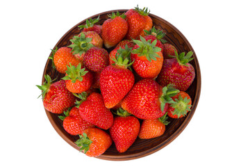 Strawberries in a wooden bowl isolated on a white background. Top view.