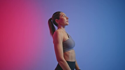 Closeup fitness woman jumping in neon sport club. Sport lady using skipping rope