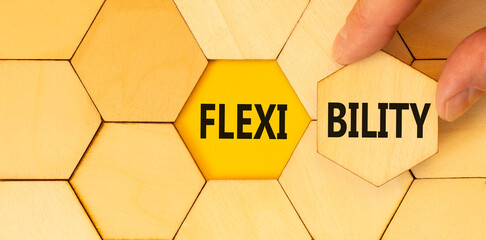 Flexibility symbol. Concept word Flexibility on beautiful wooden puzzles. Beautiful yellow...