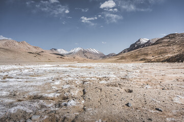 Panoramic landscape of textured Tien Shan mountains in Pamir in Tajikistan, panoramic landscape of a mountain range with snow and glaciers in summer