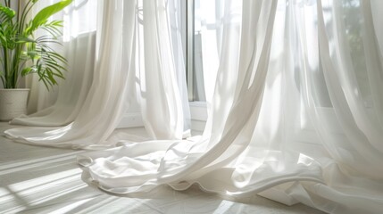 Sheer white curtains billow in a sunlit room.