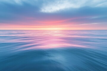 Calm ocean waves reflecting a vibrant sunset along the shoreline at twilight