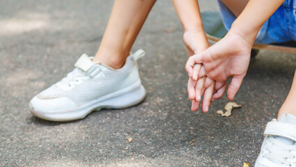 Skateboarding legs. Close-up child legs on a skateboard, skateboarding on a outdoors. Kids entertainment concept. Extreme sport. Childhood © Mariia