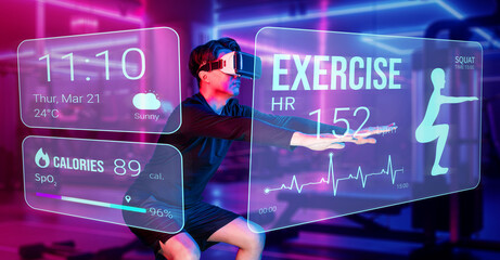 Happy asian man wearing VR glass while exercising at futuristic gym with glowing vibrant color. Male model using augmented reality technology for analysis data from holographic. Technology. Ingenuity.