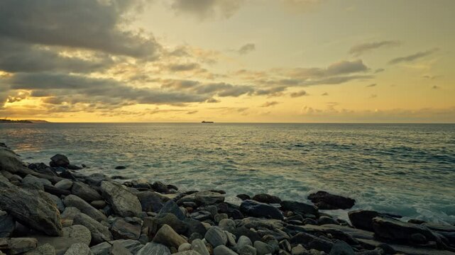 Slow motion of waves breaking on the rocks on a tropical beach at sunset. Macuto Coast, Venezuela.