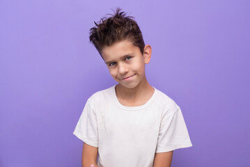 A young boy begins adolescence, his voice and character change, he begins to disobey his parents, raises his hair up, often smiles mischievously. A young boy smiles beautifully