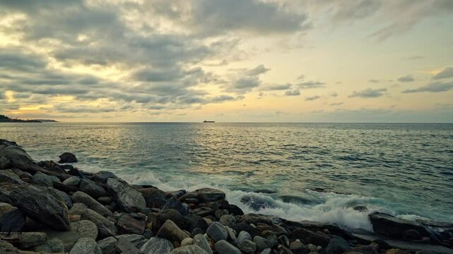 Slow motion of waves breaking on the rocks on a tropical beach at sunset. Macuto Coast, Venezuela.