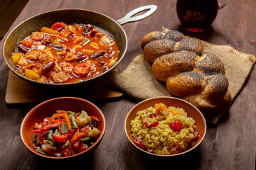 Chellent, tzimmes and bulgur on the festive table for the meal on Rosh Hashanah