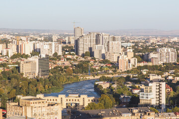 unpopular view of Tbilisi city center capital of Georgia, residential buildings, construction site and Ortachala hydroelectric power station on the Kura River