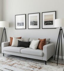 Modern living area featuring a sleek grey sofa, coordinated throw pillows, tripod floor lamps, and stylish framed wall art.