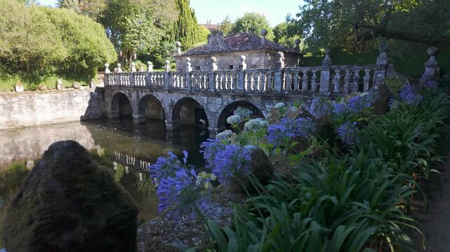 Spectacular pond with flowers and decorative sculptures in the palace of the Pazo de Oca, Galicia.