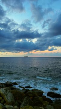 Slow motion of waves breaking on the rocks on a tropical beach at sunset. Macuto Coast, Venezuela.