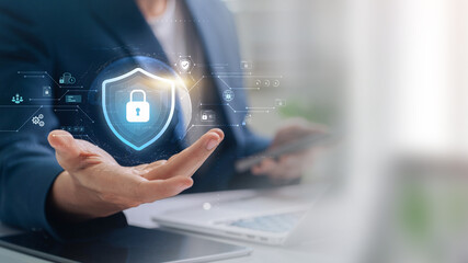 Cybersecurity and digital data protection, Business professional presenting a digital shield icon...