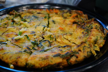 Seafood pancake is a traditional Korean dish made with seafood and green onions.