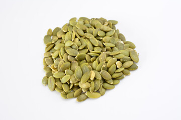 a handful of green pumpkin seeds isolated on white background