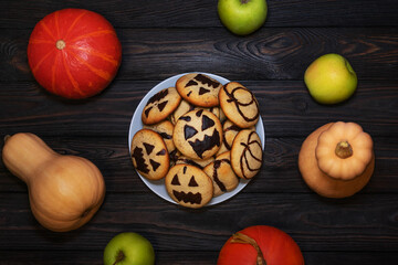 Halloween Cookies with Pumpkin Faces on a Festive Table