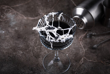 Halloween cocktail with spider cobweb
