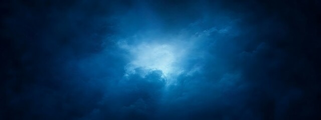 Obraz premium Abstract blue cloudy sky with light in the center.