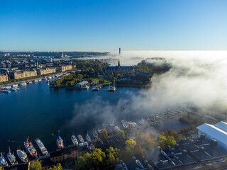Aerial view of Stockholm, Sweden. Nordic Museum, Strandvägen, Skeppsholmen. Boats and sailboats. Patchy fog and bright sunlight. Early autumn.