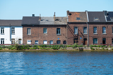 Haccourt, Ouepeye, Belgium, AUG 11, 2024 - Modest brick stone houses at the banks of the Albert Canal