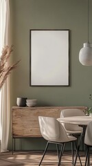 An elegant dining space with olive green walls, featuring minimalist furniture and decor, with dried pampas grass on display.