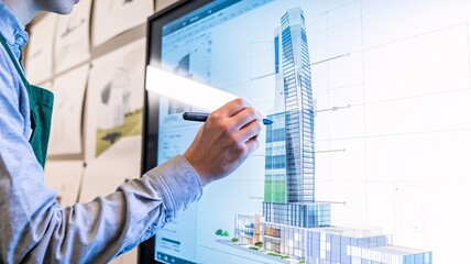 A close-up of an architect using a digital stylus on a large touchscreen to design the exterior facade of a modern, sustainable skyscraper.