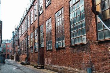 Old red brick factory building with large windows