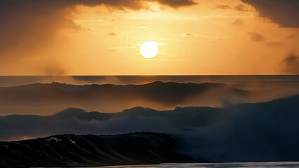 Large waves crashing on the shore as the sun sets creating a golden sky with clouds.