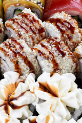 Sushi rolls with sesame, soy glaze, and whipped cream garnish