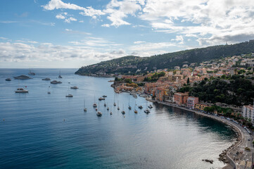 Fototapeta premium Yachts at anchor in natural harbor of Villefranche-sur-Mer on sunny summer afternoon.