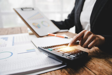 Portrait of a woman working on a tablet computer in a modern office. Make an account analysis report. real estate investment information financial and tax system concepts..