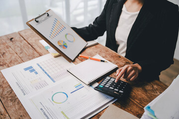 Portrait of a woman working on a tablet computer in a modern office. Make an account analysis...