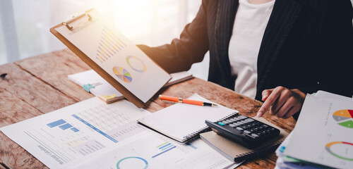 Portrait of a woman working on a tablet computer in a modern office. Make an account analysis report. real estate investment information financial and tax system concepts..