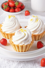 Baskets with protein cream and strawberries on a white table