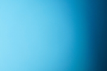 Blue background with gradient from left to right and metallic shiny effect. Gradient from light blue to dark blue with darkening to the right side. Horizontal backdrop with full copy space.