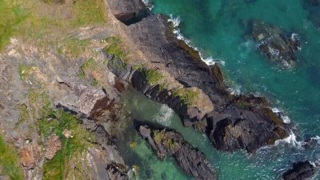 The water is gently lapping against the rocks, creating a sense of peace and tranquility. The rocks seem to be arranged in a pattern, resembling a natural sculpture.