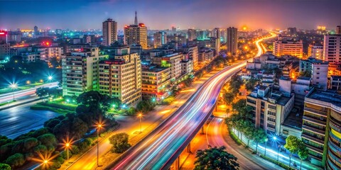 Fototapeta premium Night cityscape view of illuminated metropolitan area with light trails on the road