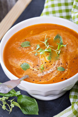 Tomato soup in white bowl
