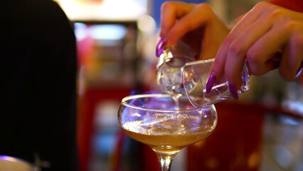 Making process of Burning cocktail absinthe by woman bartender in bar. Nightlife entertainment
