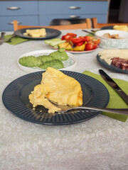 Cozy Holiday Breakfast: Vertical Candid Shot of a Dining Table with the Omelette Served in Blue Plates