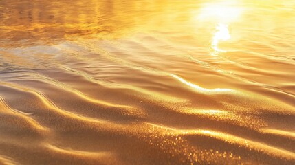 Gentle ripples on a shimmering golden surface reflecting sunlight.