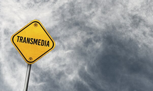 Transmedia, yellow sign with cloudy sky