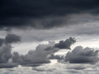 Obraz premium Low gray rain clouds thicken in the sky. The sky before the rain