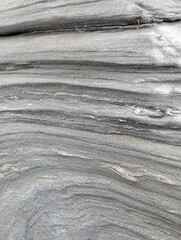 Uneven texture of gray stone with white streaks
